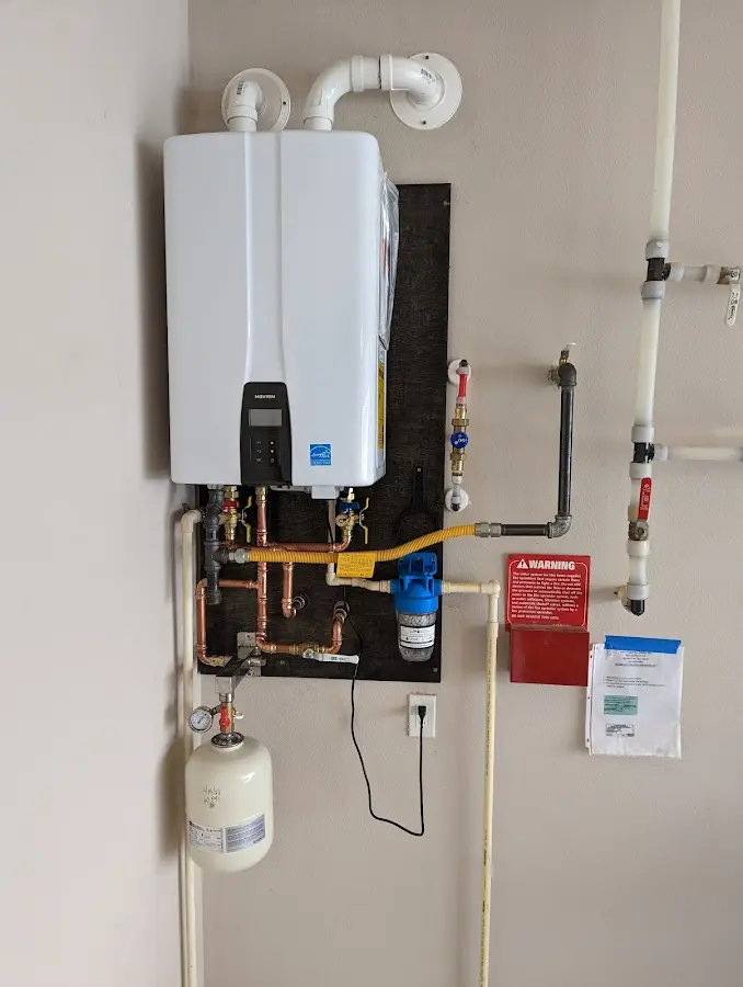 Professional plumber installing copper piping in a North Hobbs home